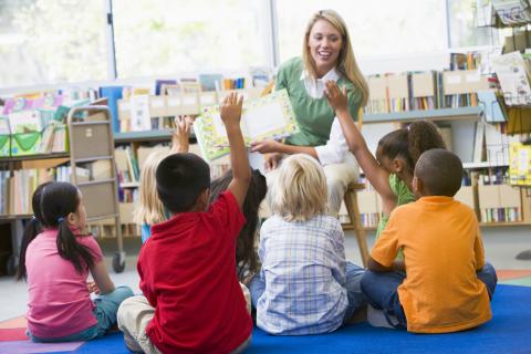 Children at story time with adult reading.