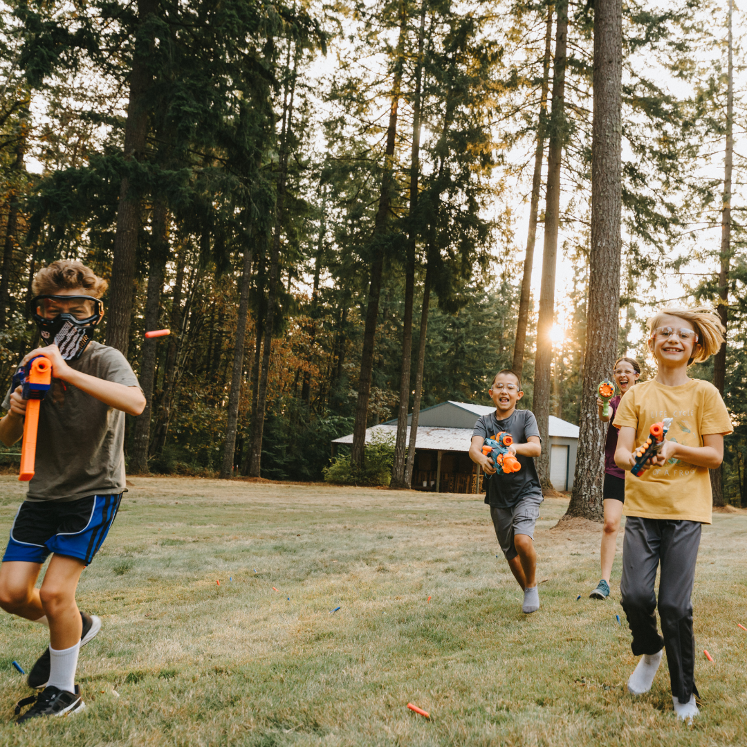 Kids running outside with nerf guns